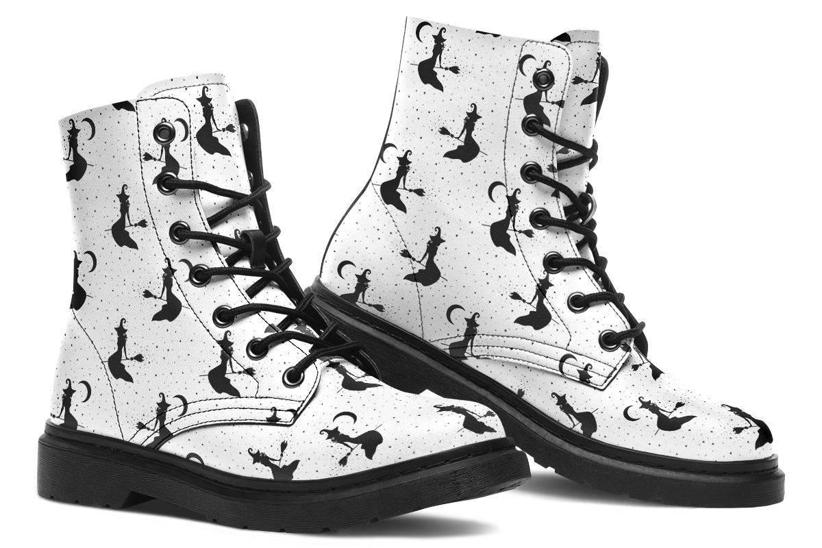 White boots with a repetitive black pattern of the silhouettes of witches on broomsticks