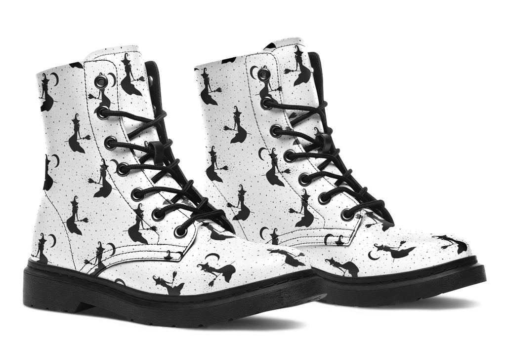 White boots with a repetitive black pattern of the silhouettes of witches on broomsticks