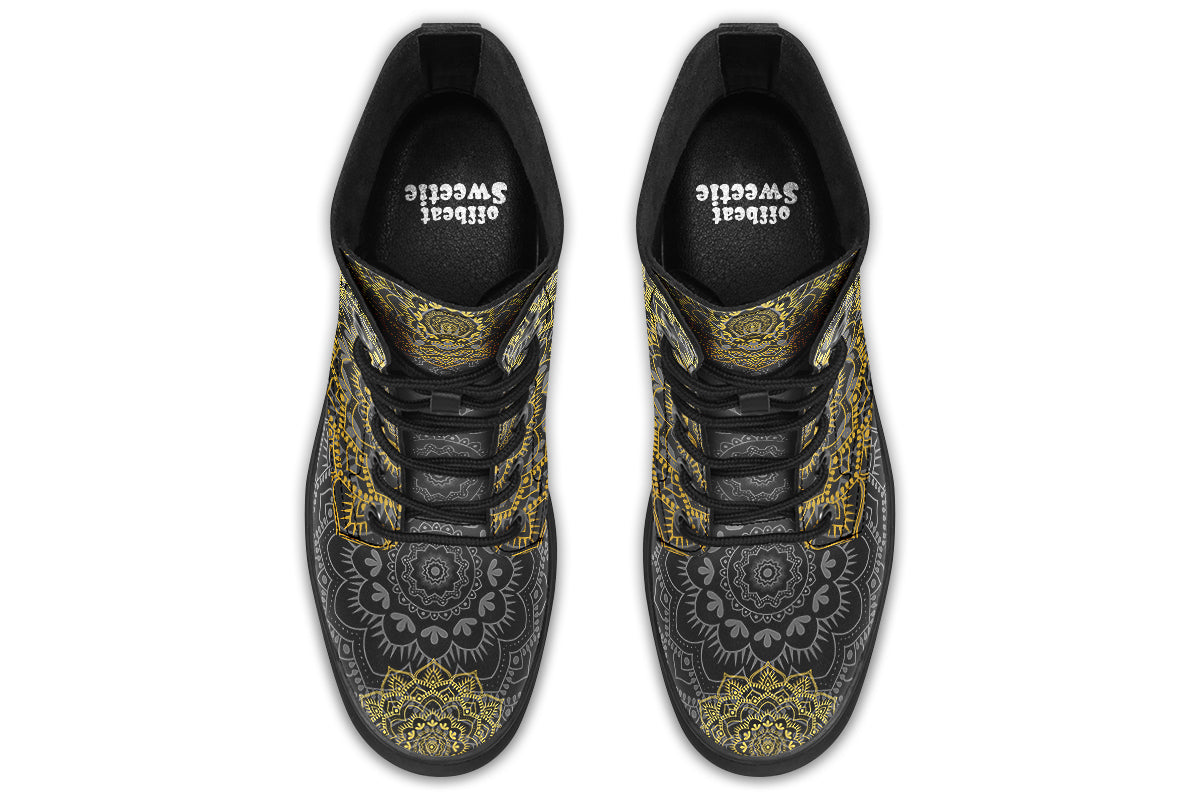 Black boots with a gold/yellow mandala design.