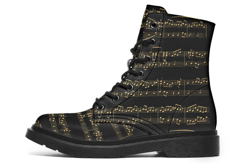 Black boots with a black sole, featuring yellowish/gold sheet music design.