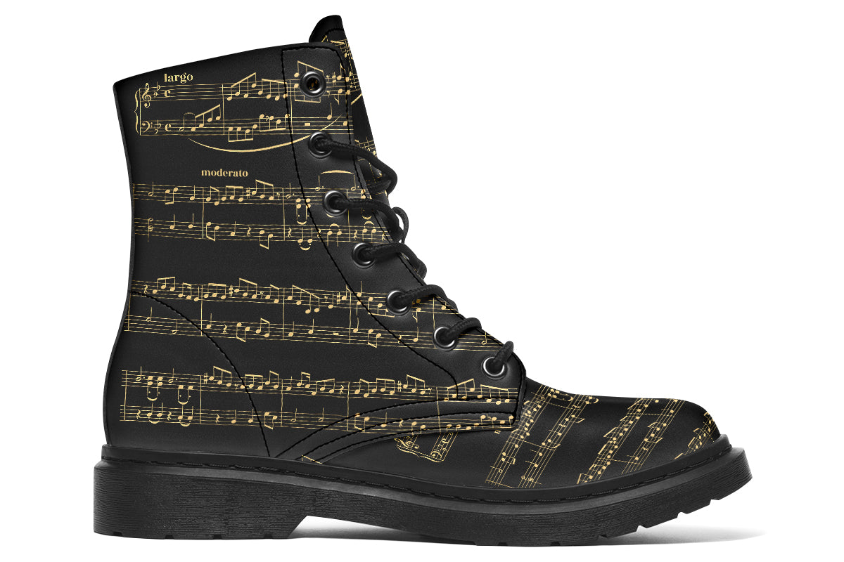 Black boots with a black sole, featuring yellowish/gold sheet music design.