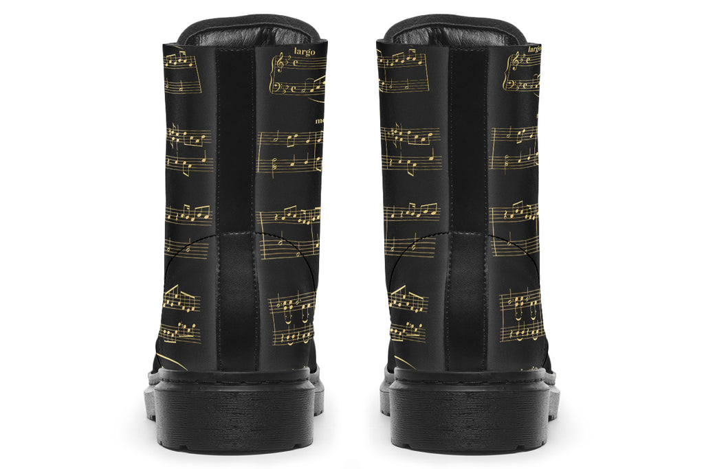 Black boots with a black sole, featuring yellowish/gold sheet music design.