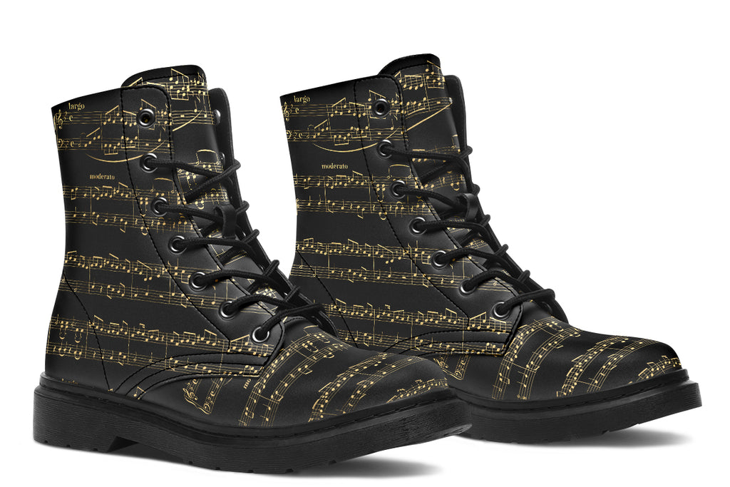 Black boots with a black sole, featuring yellowish/gold sheet music design.