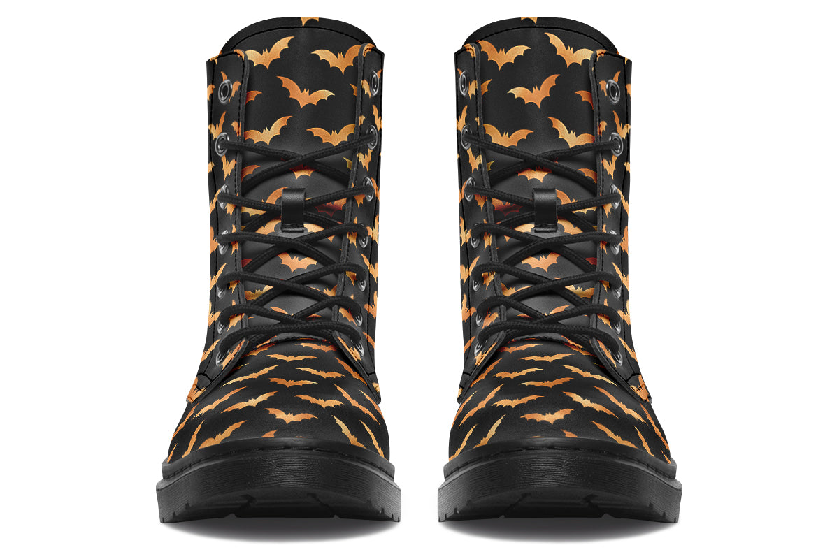 Black boots with an orange bat repetitive pattern.