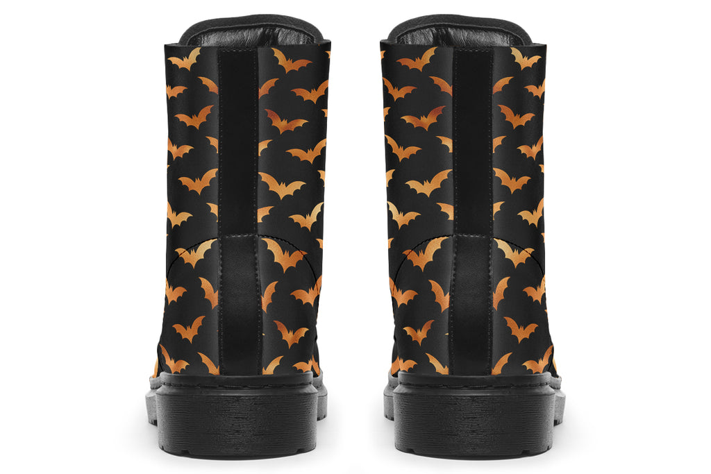 Black boots with an orange bat repetitive pattern.