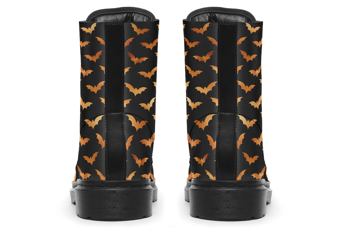 Black boots with an orange bat repetitive pattern.