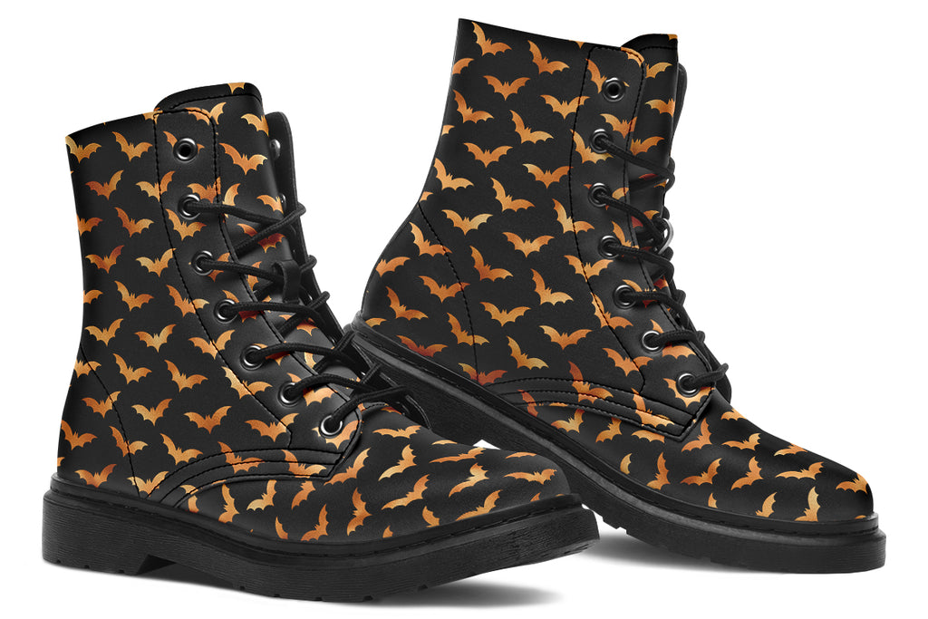 Black boots with an orange bat repetitive pattern.