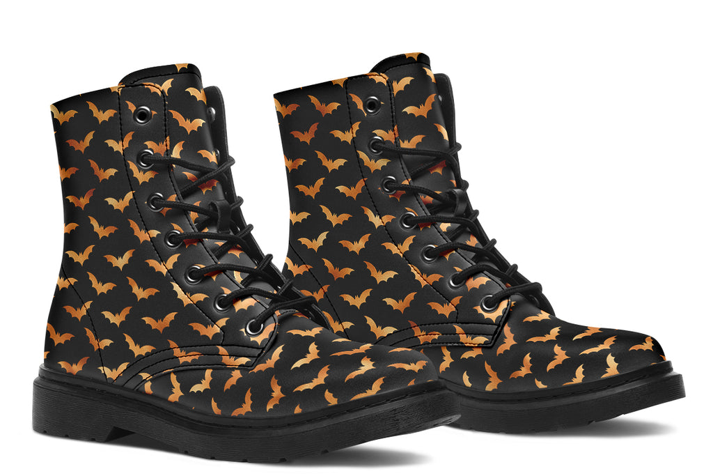 Black boots with an orange bat repetitive pattern.
