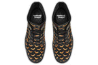 Black boots with an orange bat repetitive pattern.
