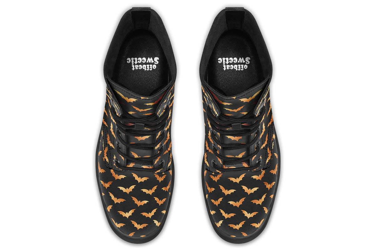Black boots with an orange bat repetitive pattern.