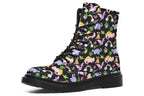 Black boots featuring a patterns of pink and purple dinosaurs, rainbows and plants.