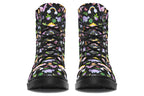 Black boots featuring a patterns of pink and purple dinosaurs, rainbows and plants.
