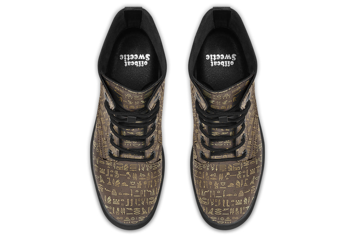 Dark brown boots with a gold hieroglyphics pattern