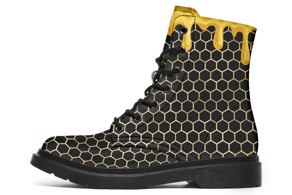 Black boots with a yellow honeycomb pattern, with the image of dripping honey on the top of the boots as if the honey is dripping down the boots