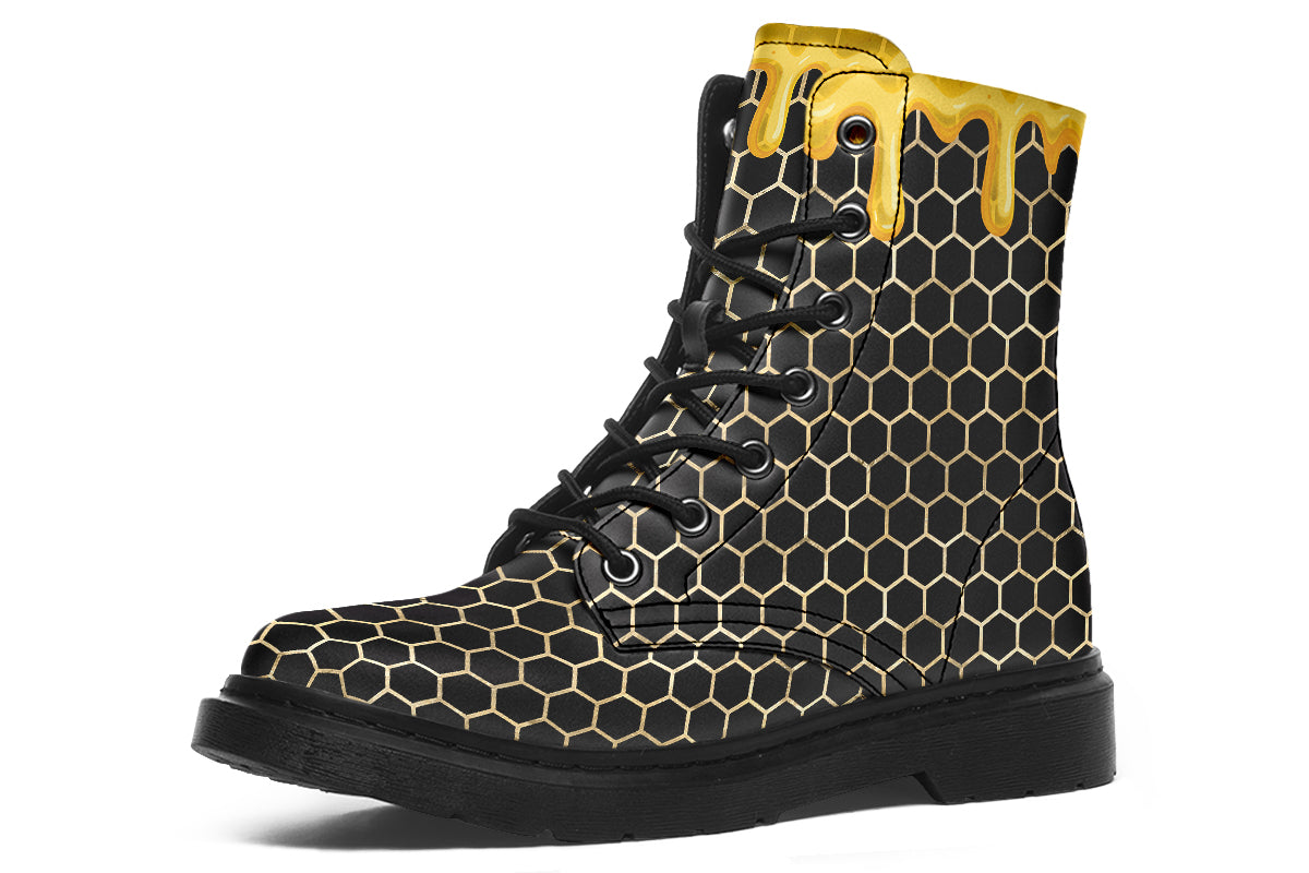 Black boots with a yellow honeycomb pattern, with the image of dripping honey on the top of the boots as if the honey is dripping down the boots