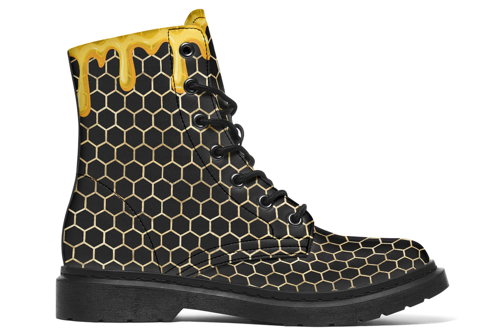 Black boots with a yellow honeycomb pattern, with the image of dripping honey on the top of the boots as if the honey is dripping down the boots