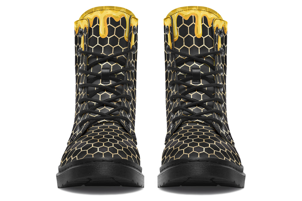 Black boots with a yellow honeycomb pattern, with the image of dripping honey on the top of the boots as if the honey is dripping down the boots
