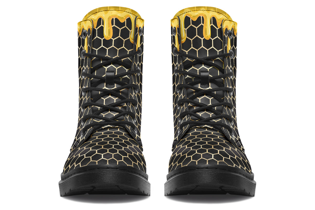 Black boots with a yellow honeycomb pattern, with the image of dripping honey on the top of the boots as if the honey is dripping down the boots