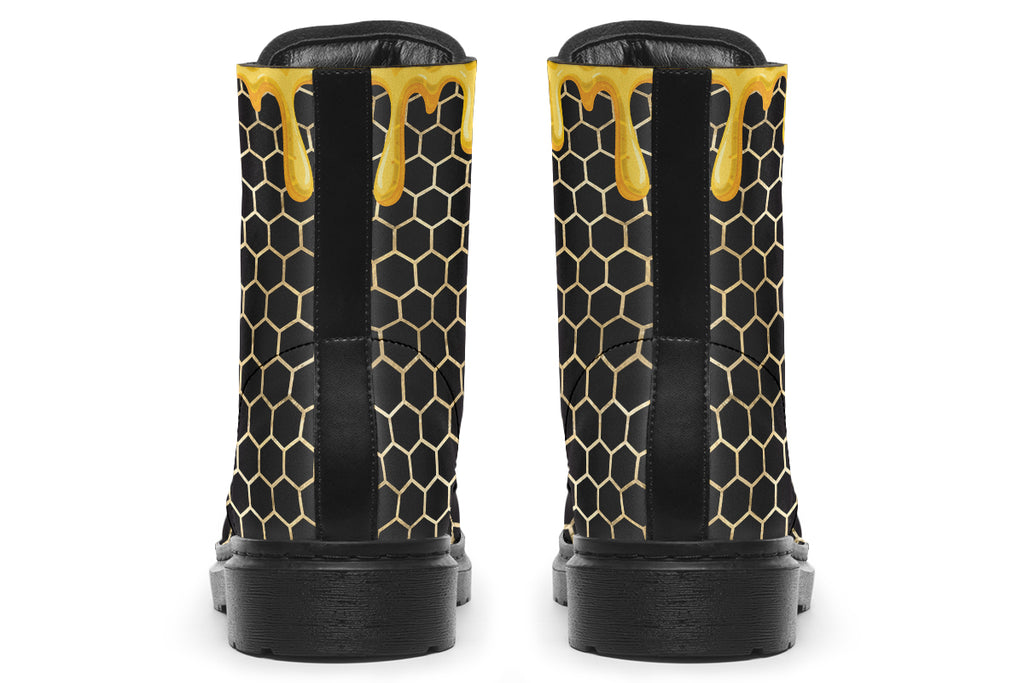 Black boots with a yellow honeycomb pattern, with the image of dripping honey on the top of the boots as if the honey is dripping down the boots