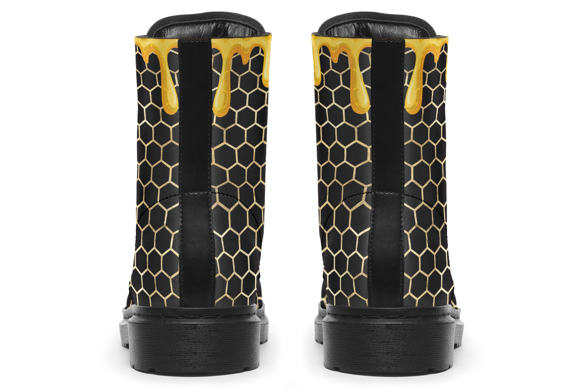 Black boots with a yellow honeycomb pattern, with the image of dripping honey on the top of the boots as if the honey is dripping down the boots