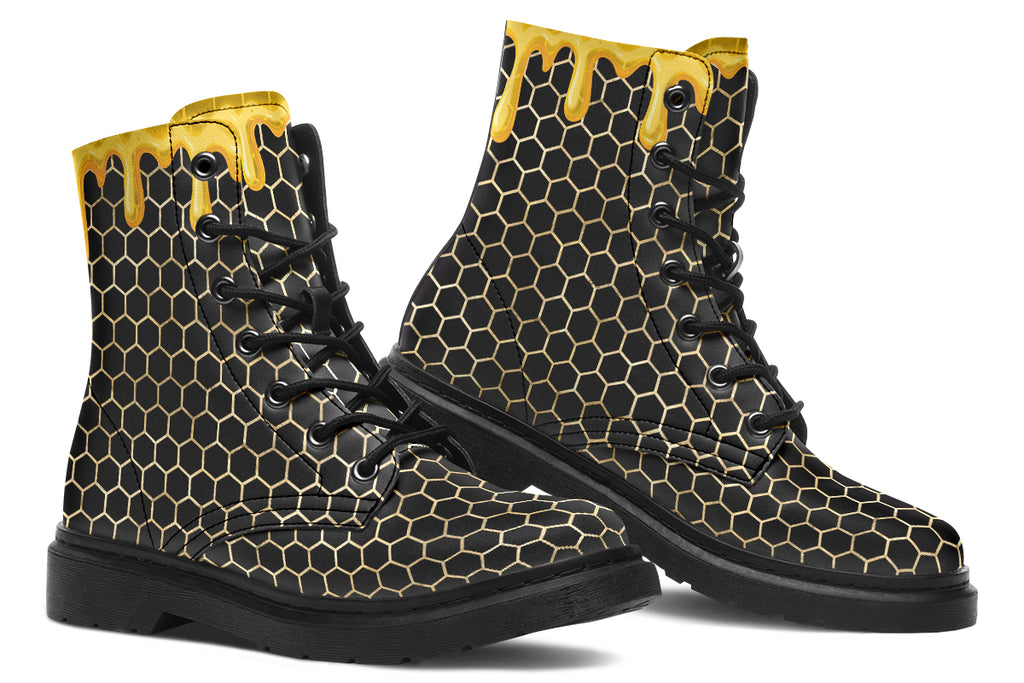 Black boots with a yellow honeycomb pattern, with the image of dripping honey on the top of the boots as if the honey is dripping down the boots