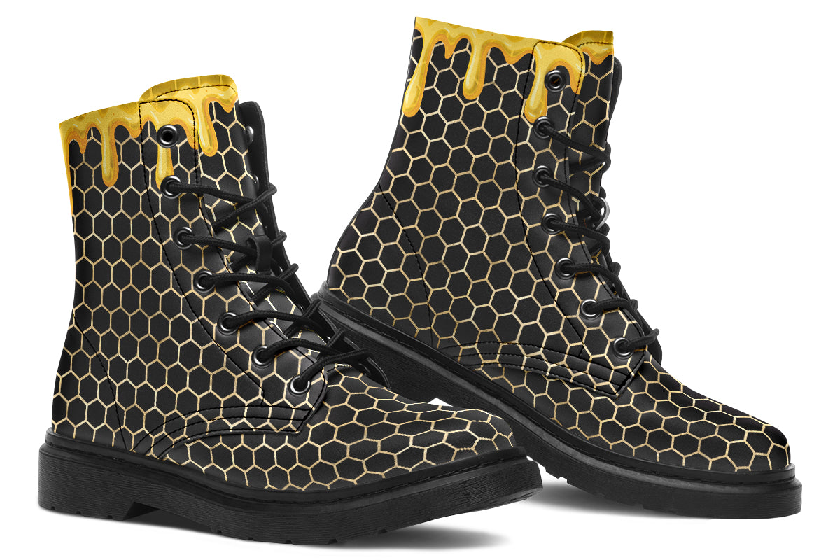 Black boots with a yellow honeycomb pattern, with the image of dripping honey on the top of the boots as if the honey is dripping down the boots