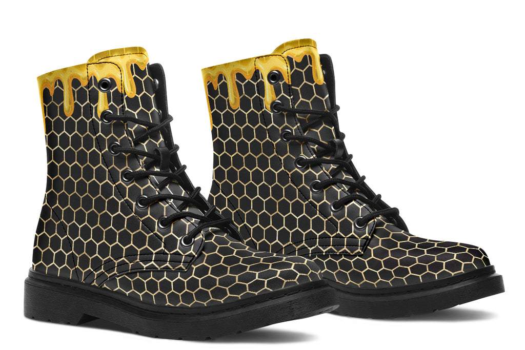 Black boots with a yellow honeycomb pattern, with the image of dripping honey on the top of the boots as if the honey is dripping down the boots