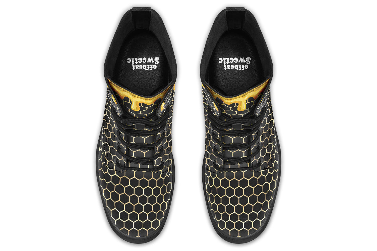 Black boots with a yellow honeycomb pattern, with the image of dripping honey on the top of the boots as if the honey is dripping down the boots