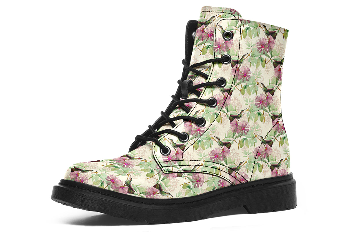 Cream-coloured boots with a pattern of dark green hummingbirds, pink flowers and green leaves