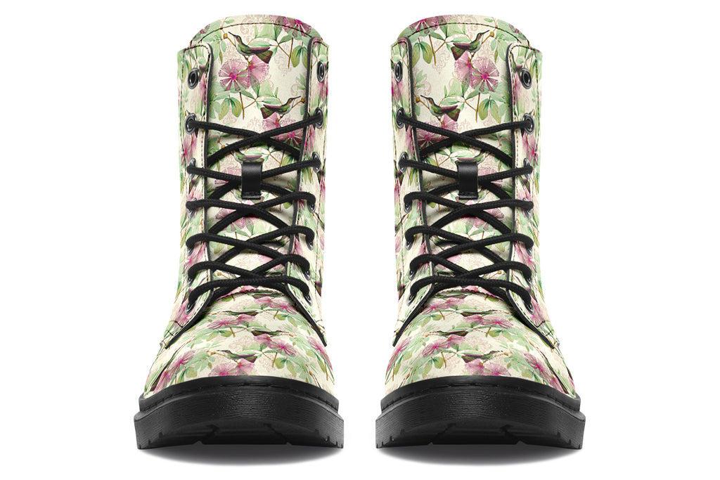 Cream-coloured boots with a pattern of dark green hummingbirds, pink flowers and green leaves