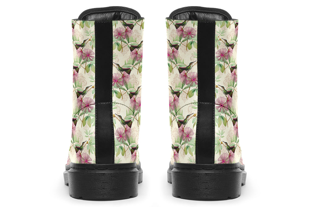 Cream-coloured boots with a pattern of dark green hummingbirds, pink flowers and green leaves