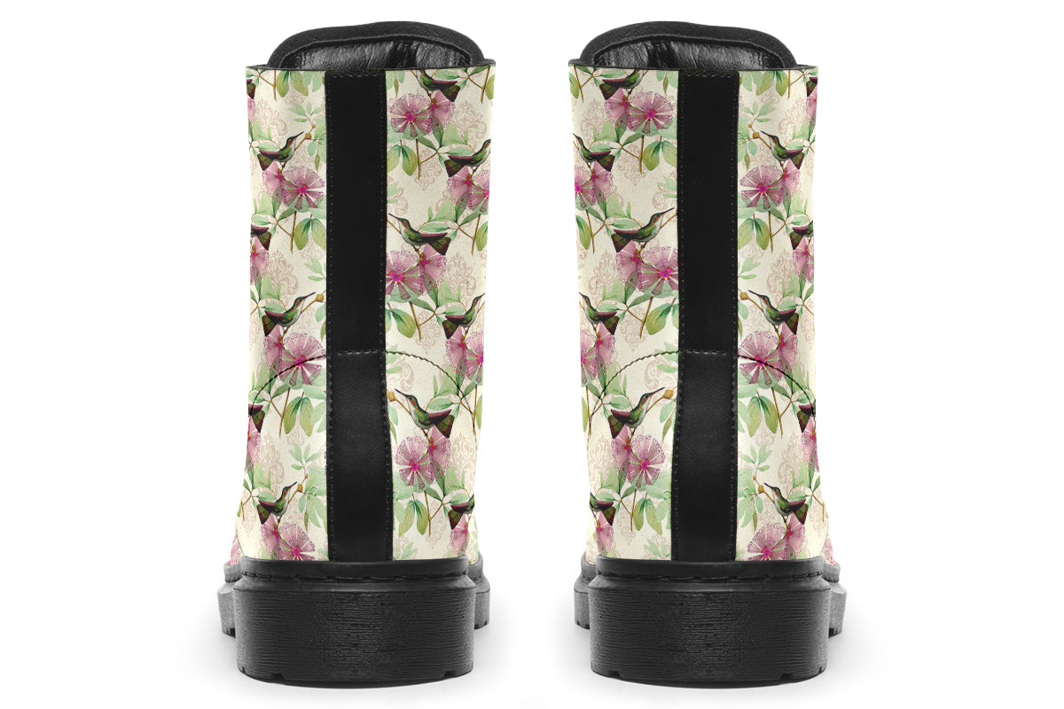 Cream-coloured boots with a pattern of dark green hummingbirds, pink flowers and green leaves