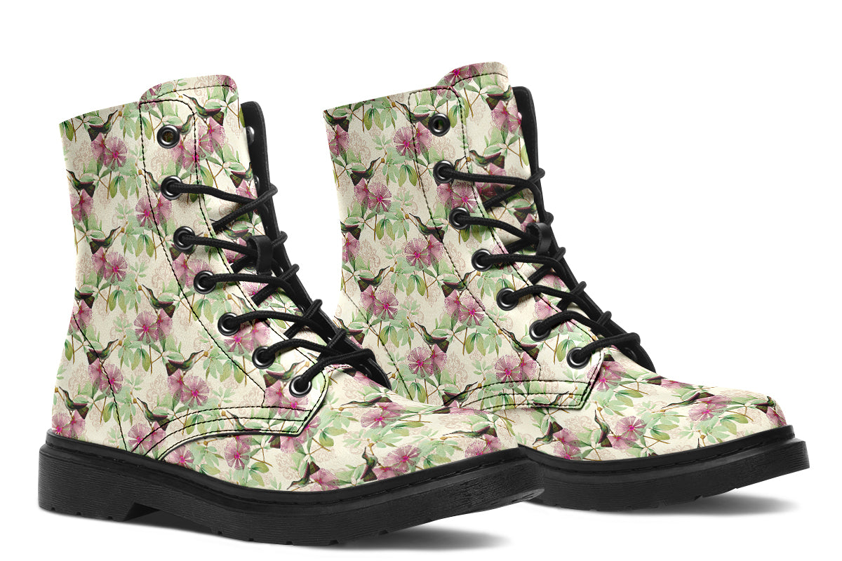 Cream-coloured boots with a pattern of dark green hummingbirds, pink flowers and green leaves