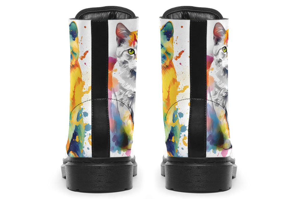 White boots, each with a different cat image, with watercolour splashes of colour coming out from behind them