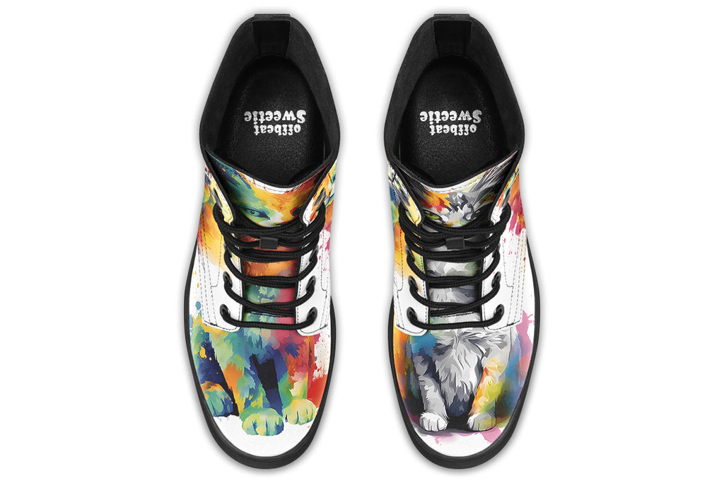 White boots, each with a different cat image, with watercolour splashes of colour coming out from behind them