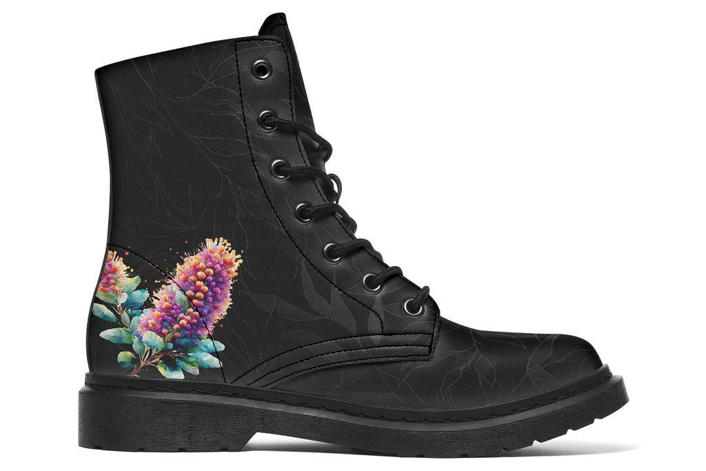 Boots featuring a subtle black leave patterned background, with a watercolour-style image of a kookaburra on the outsides of the boots, and purple and red wattle on the inside panels. 