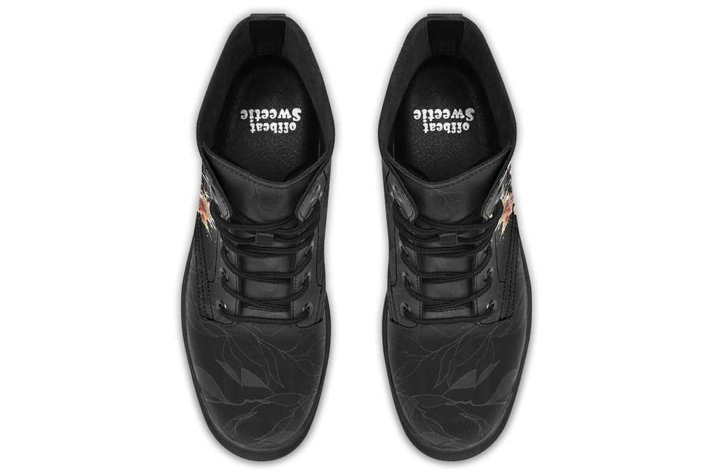 Boots featuring a subtle black leave patterned background, with a watercolour-style image of a kookaburra on the outsides of the boots, and purple and red wattle on the inside panels. 