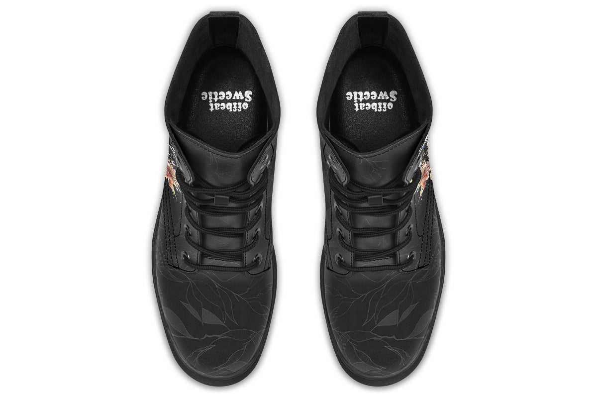 Boots featuring a subtle black leave patterned background, with a watercolour-style image of a kookaburra on the outsides of the boots, and purple and red wattle on the inside panels. 