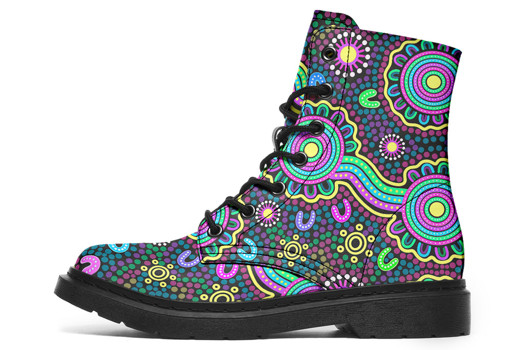 Indigenous Australian dot patterned design on boots with a black sole. The design has multiple colours, including pink, blue, green, purple, yellow and white, on a black background.