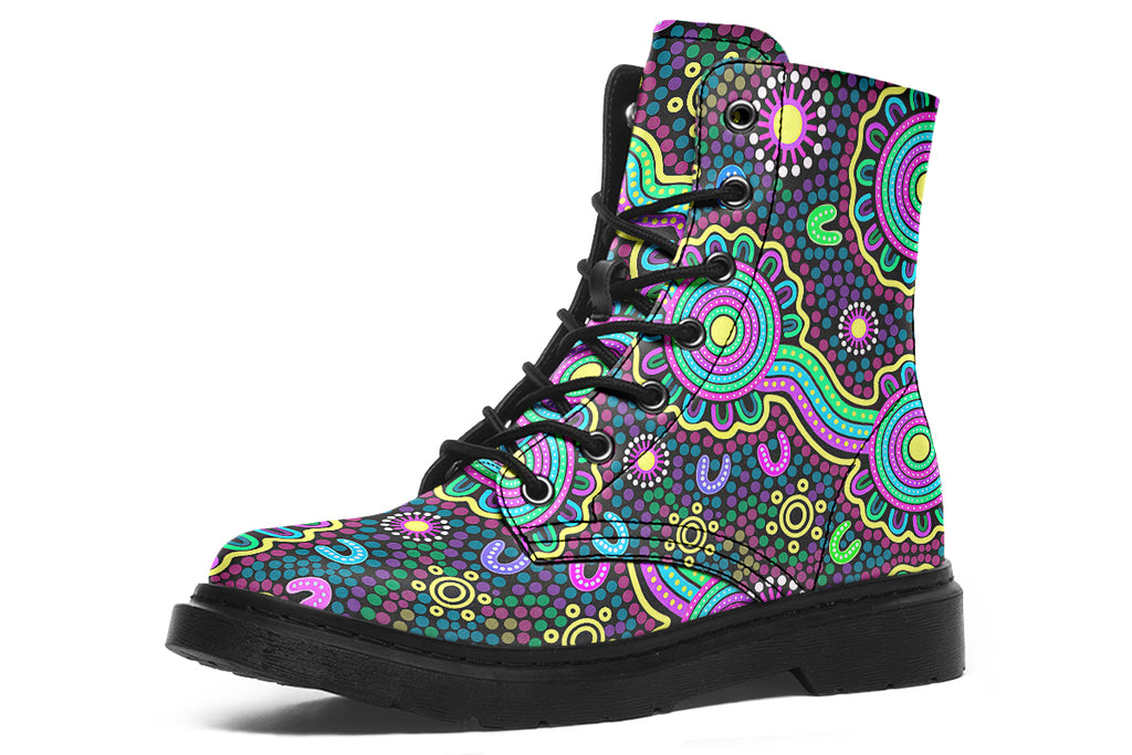 Indigenous Australian dot patterned design on boots with a black sole. The design has multiple colours, including pink, blue, green, purple, yellow and white, on a black background.