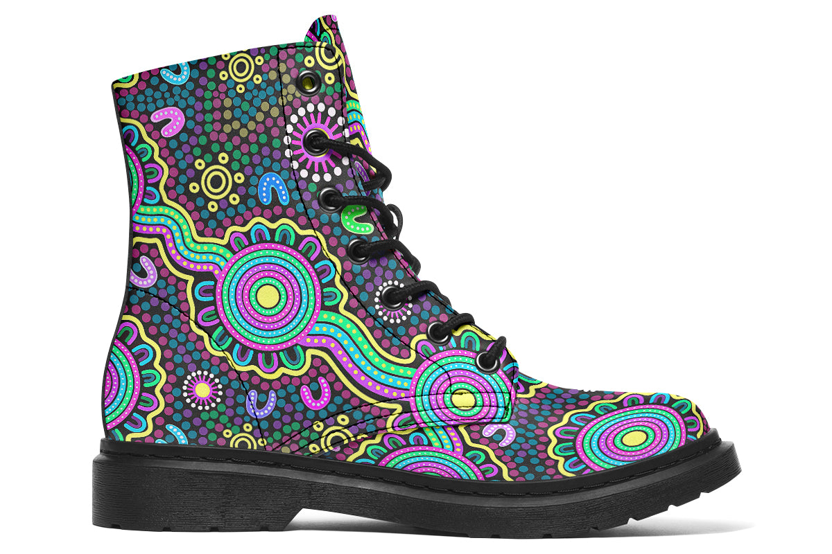 Indigenous Australian dot patterned design on boots with a black sole. The design has multiple colours, including pink, blue, green, purple, yellow and white, on a black background.