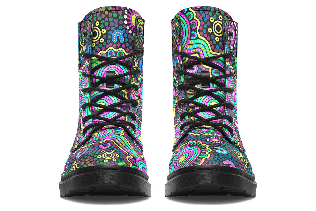 Indigenous Australian dot patterned design on boots with a black sole. The design has multiple colours, including pink, blue, green, purple, yellow and white, on a black background.