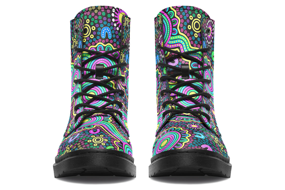 Indigenous Australian dot patterned design on boots with a black sole. The design has multiple colours, including pink, blue, green, purple, yellow and white, on a black background.