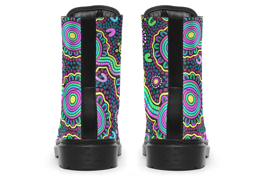 Indigenous Australian dot patterned design on boots with a black sole. The design has multiple colours, including pink, blue, green, purple, yellow and white, on a black background.