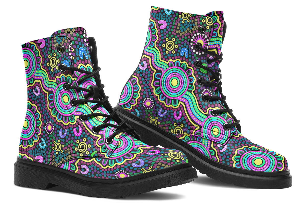 Indigenous Australian dot patterned design on boots with a black sole. The design has multiple colours, including pink, blue, green, purple, yellow and white, on a black background.