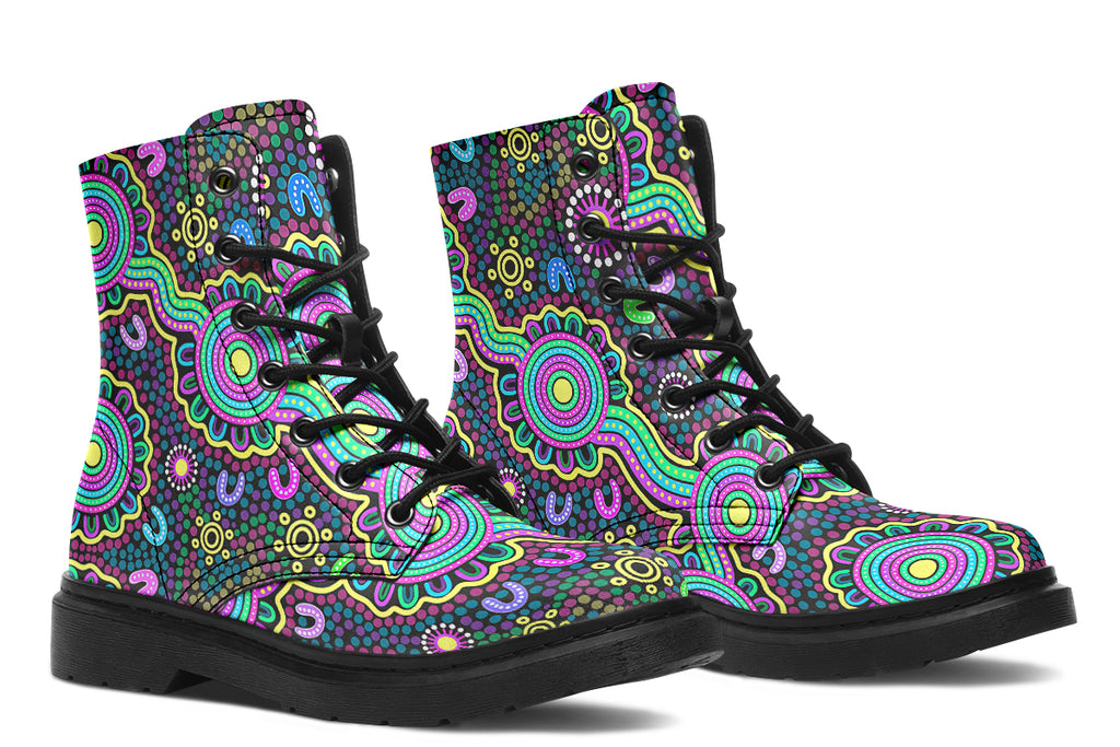 Indigenous Australian dot patterned design on boots with a black sole. The design has multiple colours, including pink, blue, green, purple, yellow and white, on a black background.