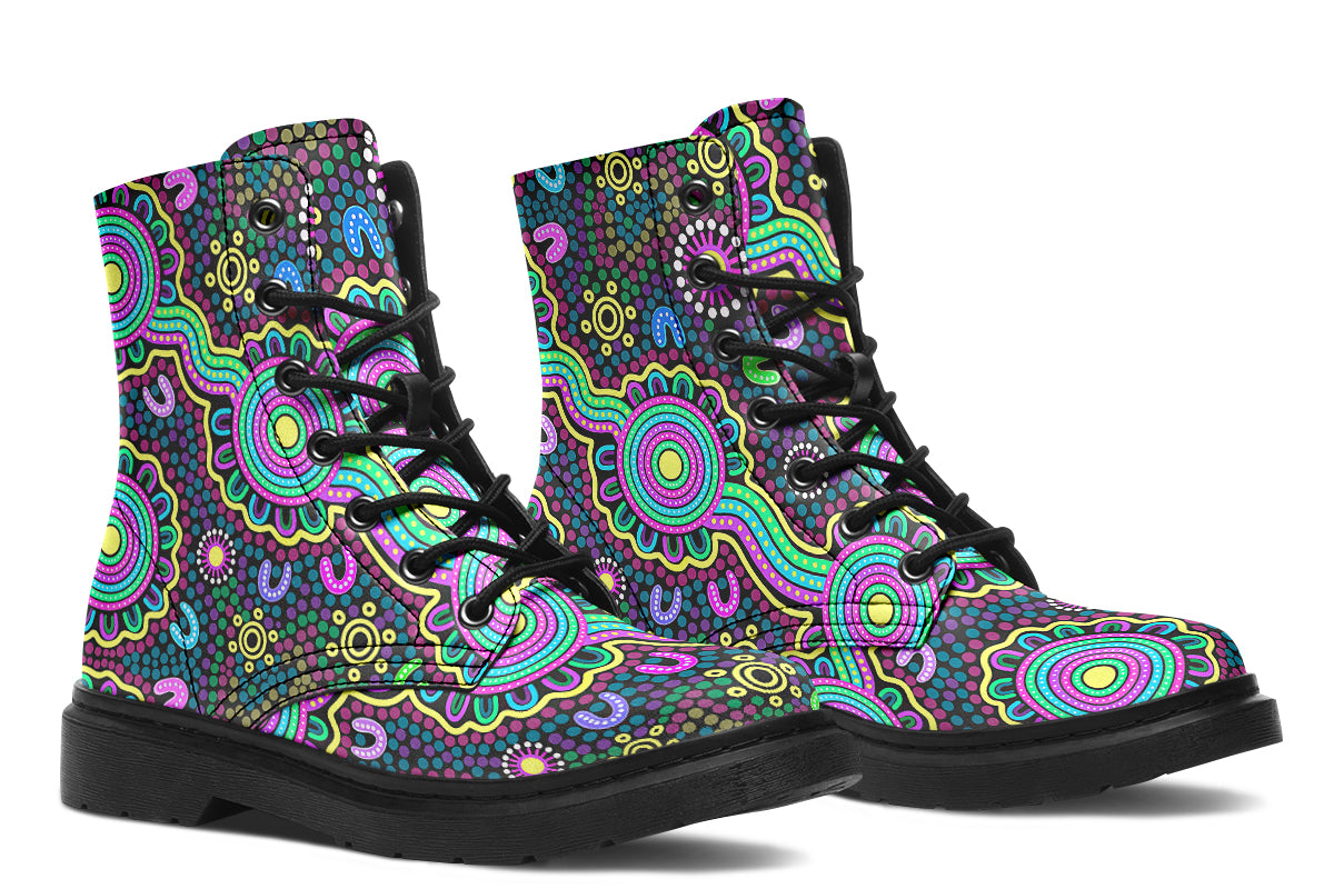 Indigenous Australian dot patterned design on boots with a black sole. The design has multiple colours, including pink, blue, green, purple, yellow and white, on a black background.