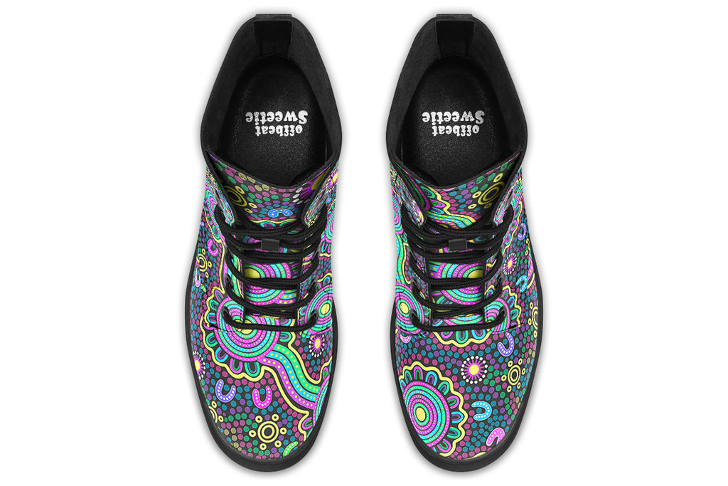 Indigenous Australian dot patterned design on boots with a black sole. The design has multiple colours, including pink, blue, green, purple, yellow and white, on a black background.