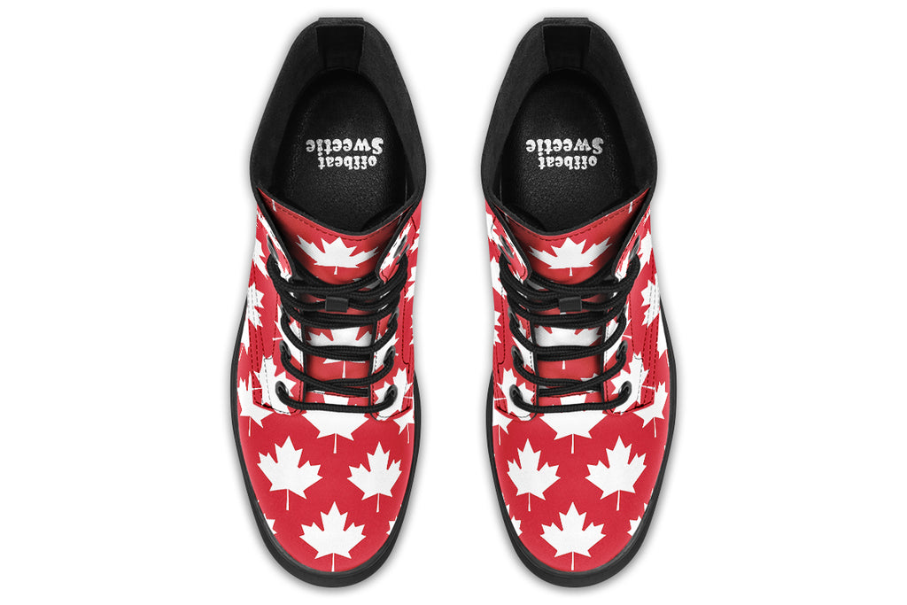 Red boots with white maple leaf patterns all over them