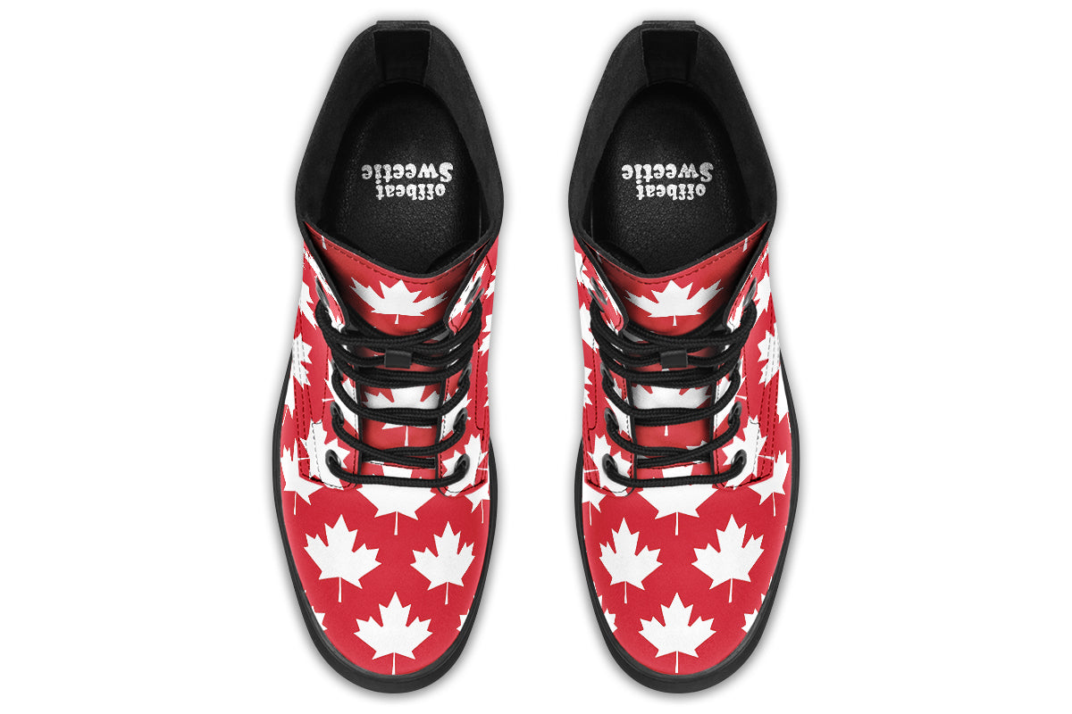 Red boots with white maple leaf patterns all over them